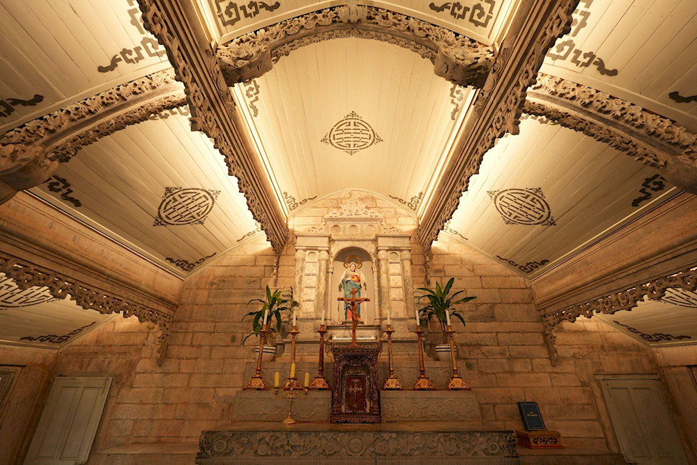 The intricately carved stone altar in the Church of the Sacred Heart features statues of the Virgin Mary 